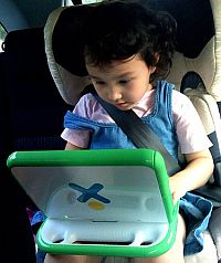 Little girld usign XO1 klaptop in the car